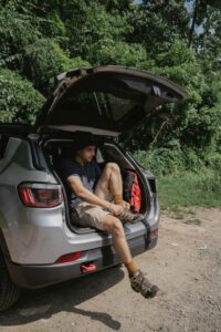 A man sitting in the trunk of an SUV